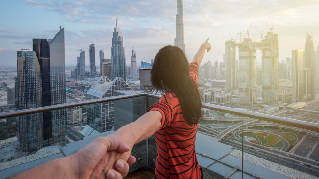 Viaggiatori che osservano lo skyline di Dubai da un rooftop, pronti a scoprire la città